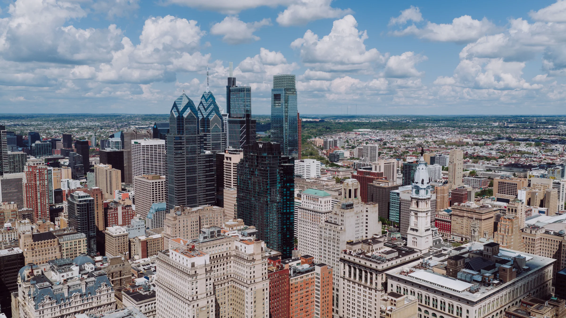 Philadelphia skyline beneath a blue summer sky